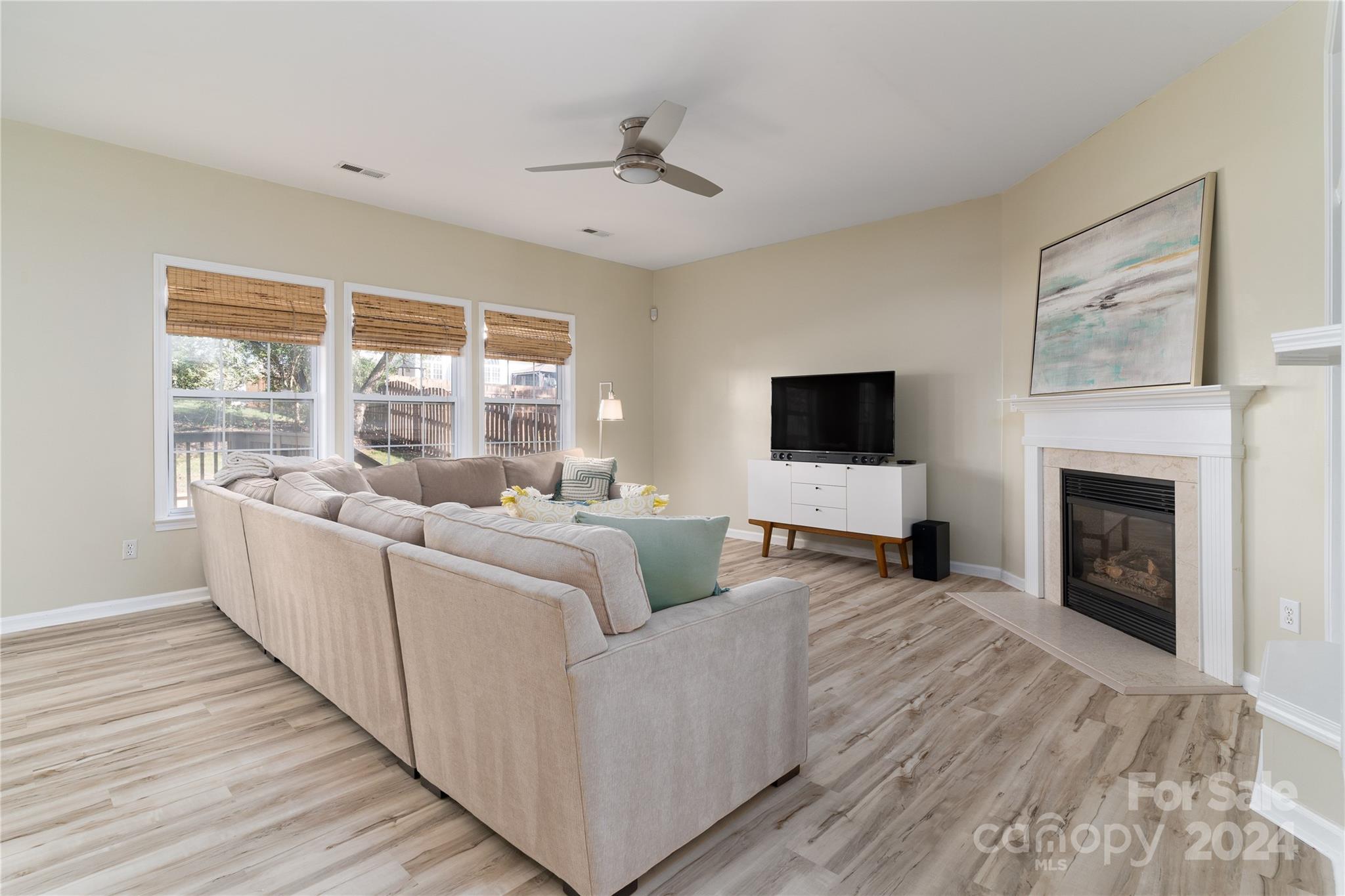 9427 Culcairn Road Huntersville, NC 28078 - Photo 18 of 39 a living room with furniture and a flat screen tv