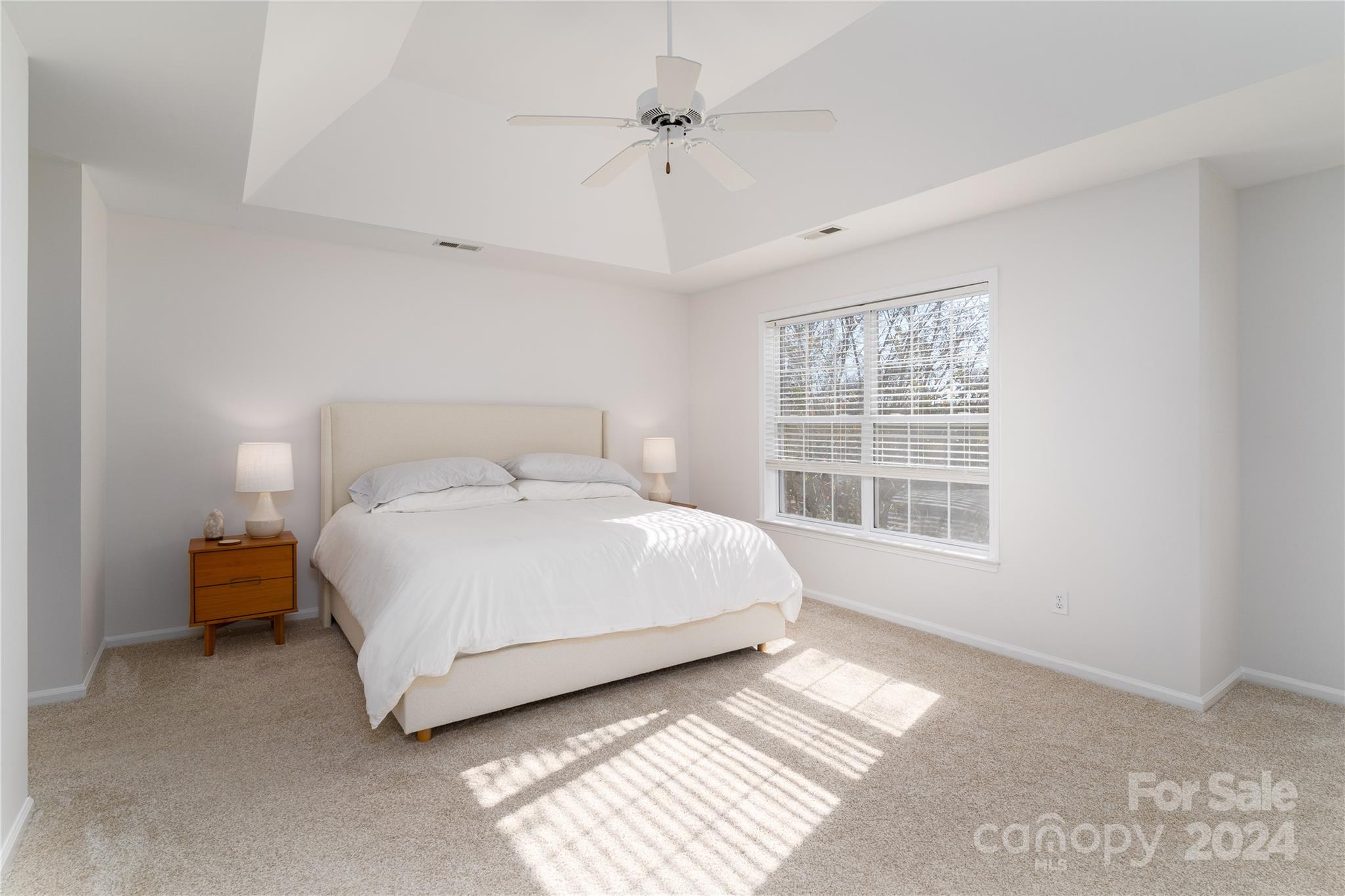 9427 Culcairn Road Huntersville, NC 28078 - Photo 23 of 39 a bedroom with a bed lamp and a window