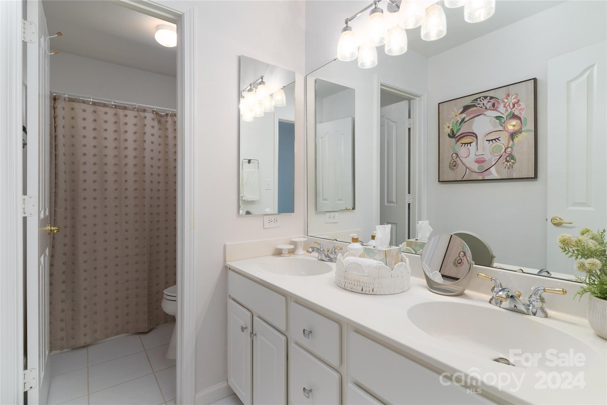 9427 Culcairn Road Huntersville, NC 28078 - Photo 29 of 39 a bathroom with double vanity sinks a vanity and a mirror