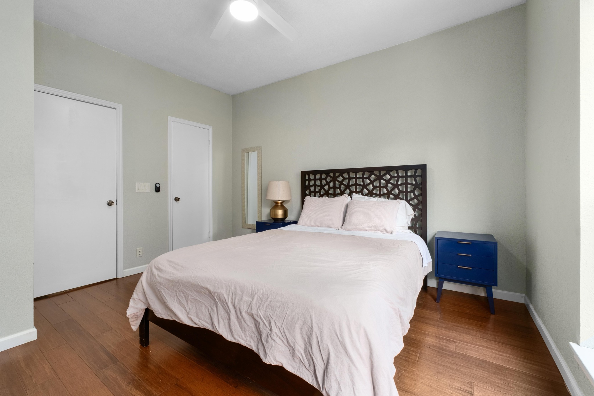 802 South 1st Street, Unit 115 Austin, TX 78704 - Photo 13 of 21 a bedroom with a bed and wooden floor