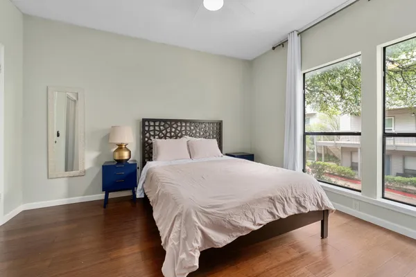 a bedroom with a bed and a large window