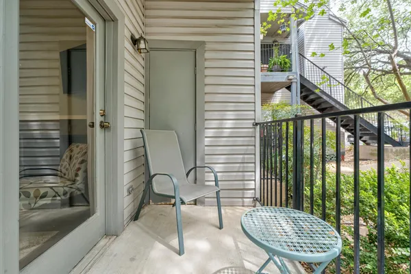a view of a balcony with chair and potted plant