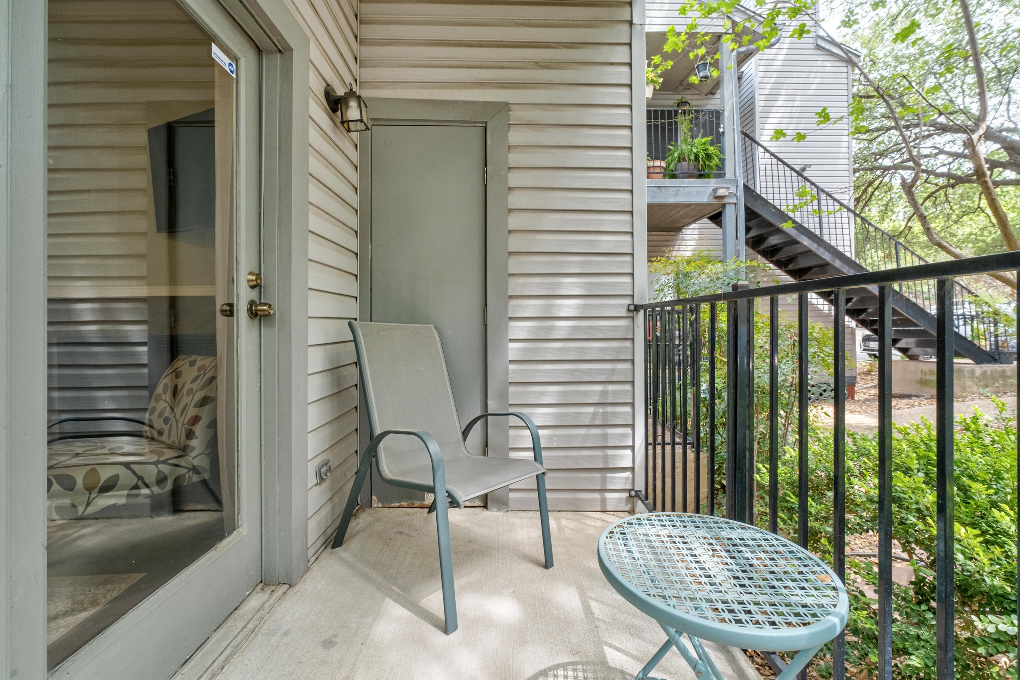 802 South 1st Street, Unit 115 Austin, TX 78704 - Photo 18 of 21 a view of a balcony with chair and potted plant