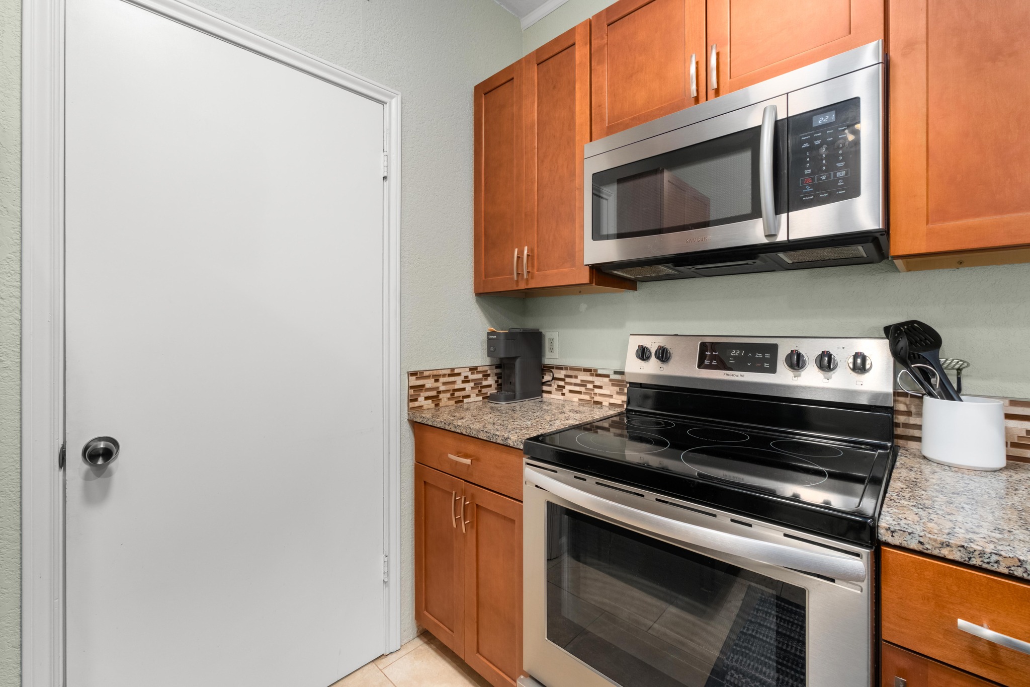 802 South 1st Street, Unit 115 Austin, TX 78704 - Photo 8 of 21 a kitchen with stainless steel appliances granite countertop a stove and a microwave