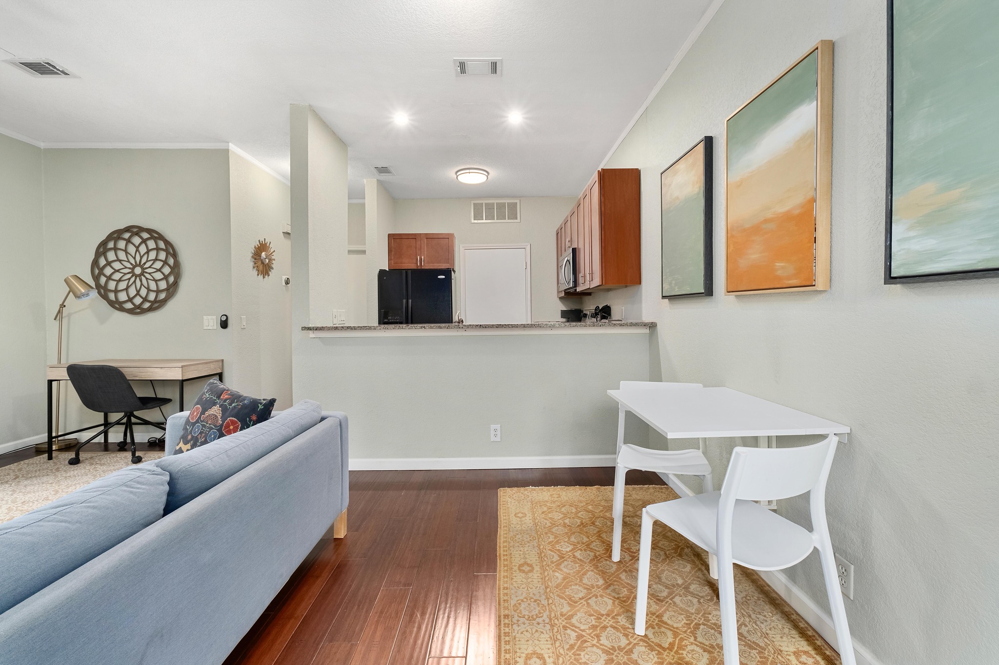 802 South 1st Street, Unit 115 Austin, TX 78704 - Photo 9 of 21 a living room with furniture and a wooden floor