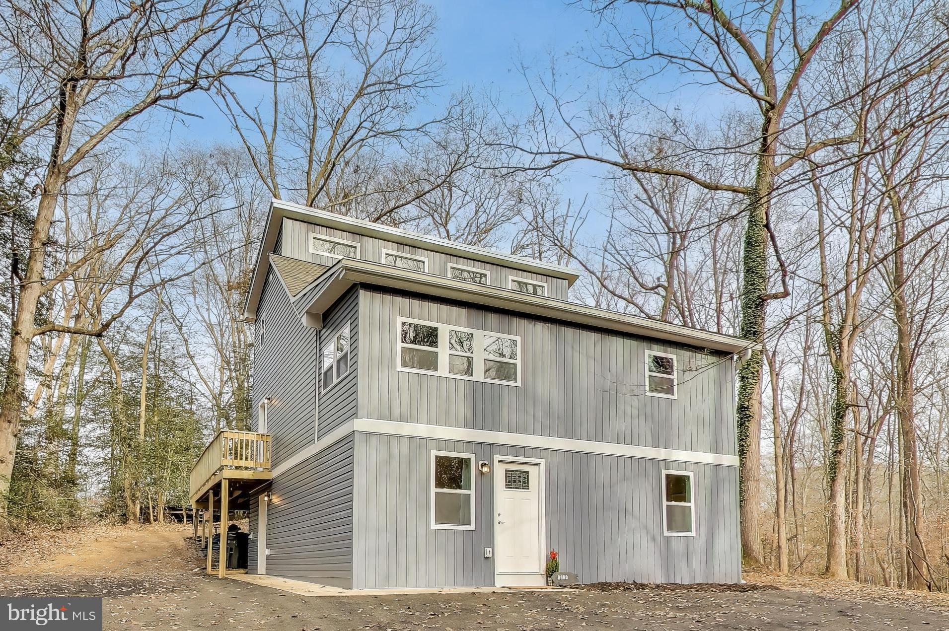 front view of a house with a dry trees