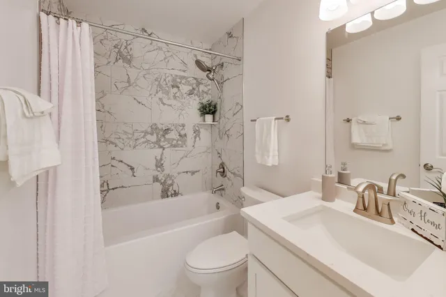 a bathroom with a sink a toilet and a bathtub