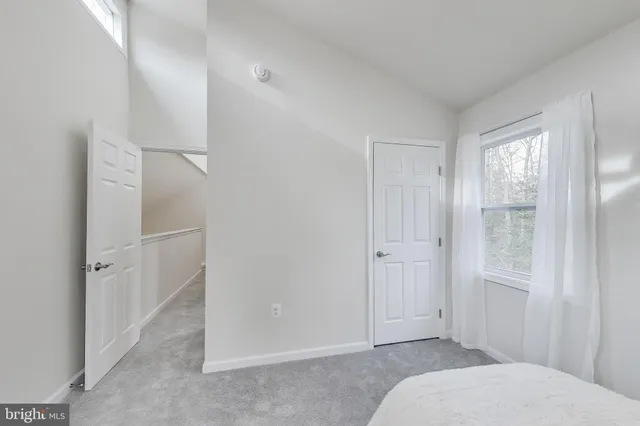 a bedroom with a bed and hallway