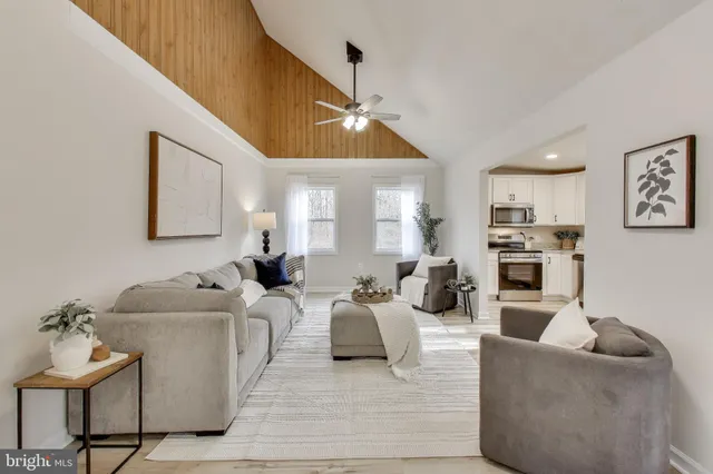 a living room with furniture and a kitchen