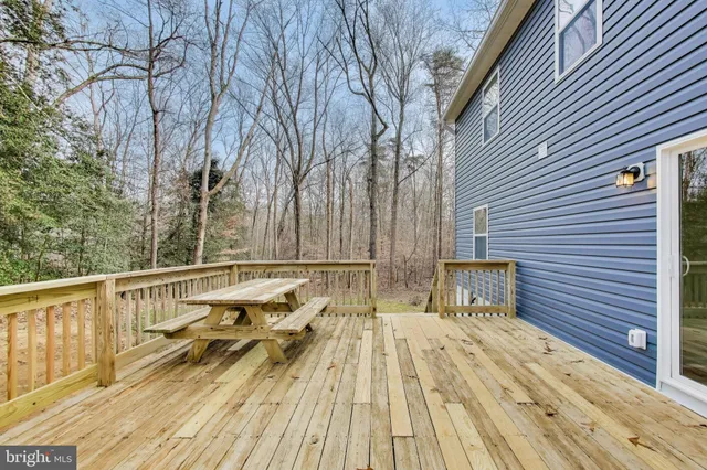 a view of balcony with wooden floor and fence
