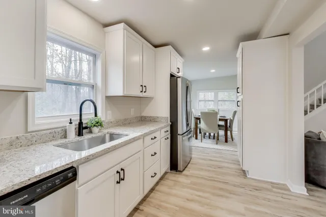 a kitchen with stainless steel appliances granite countertop a refrigerator and a sink