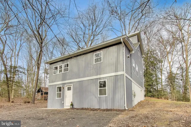 a view of a house with a large tree