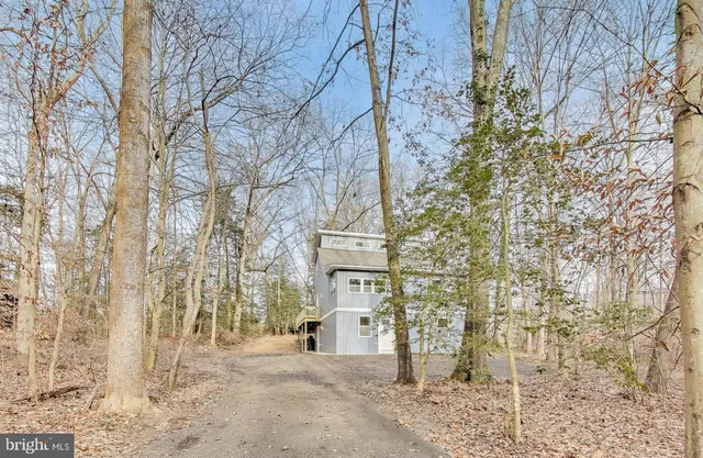 a view of a brick buildings with yard and wooden fence