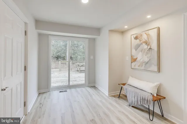 a view of room with window and wooden floor