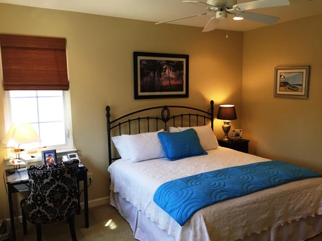 136 South Zander Way Santa Rosa Beach, FL 32459 - Photo 12 of 27 a bedroom with a bed and wooden floor