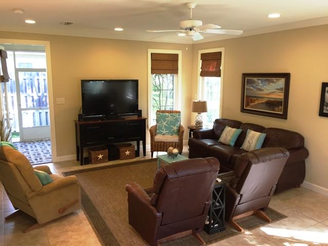 136 South Zander Way Santa Rosa Beach, FL 32459 - Photo 3 of 27 a living room with furniture a flat screen tv and a large window