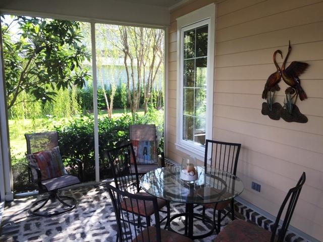 136 South Zander Way Santa Rosa Beach, FL 32459 - Photo 23 of 27 a view of a patio with table and chairs and potted plants