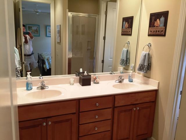 136 South Zander Way Santa Rosa Beach, FL 32459 - Photo 9 of 27 a bathroom with double vanity sinks and a mirror