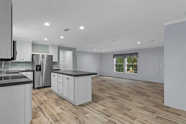 a kitchen with stainless steel appliances a refrigerator and a stove