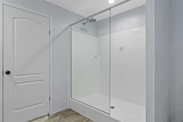 a bathroom with a glass shower door