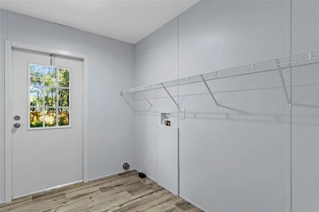 a view of a room with wooden floor