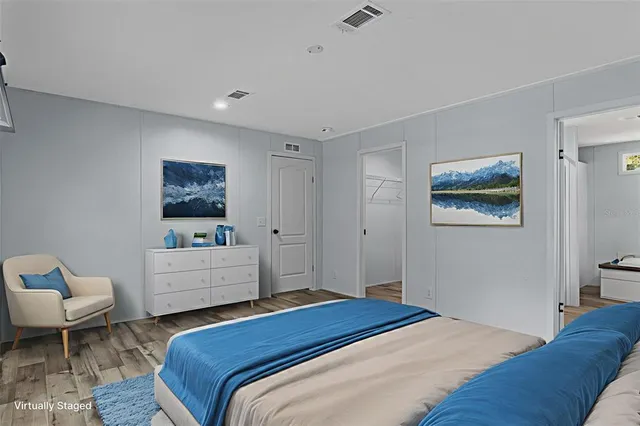 a bedroom with a bed and a couch