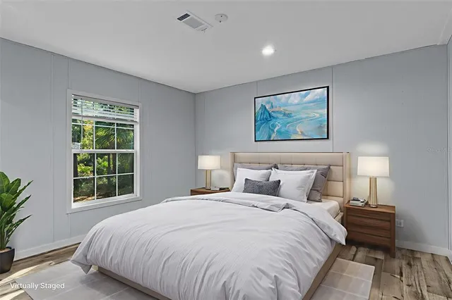 a bedroom with a large bed and a window