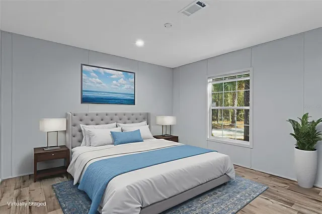 a bedroom with bed and a window