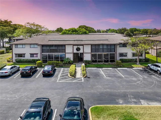 a view of a chairs and tables in the back yard