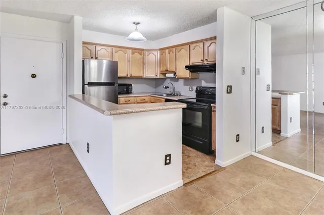 a kitchen with cabinets and a stainless steel appliances
