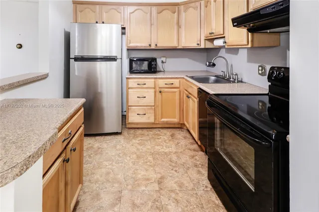 a kitchen with a sink stove and refrigerator