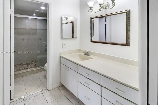 a bathroom with a shower sink and mirror