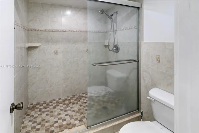a bathroom with a shower toilet and a sink