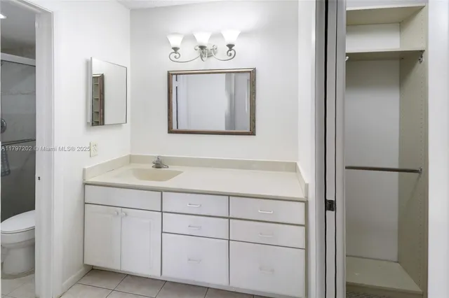 a bathroom with a sink a toilet and mirror