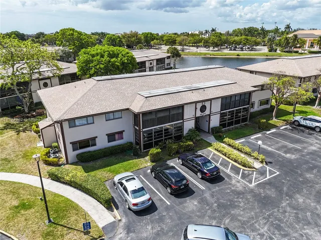an aerial view of a house with pool table and chairs