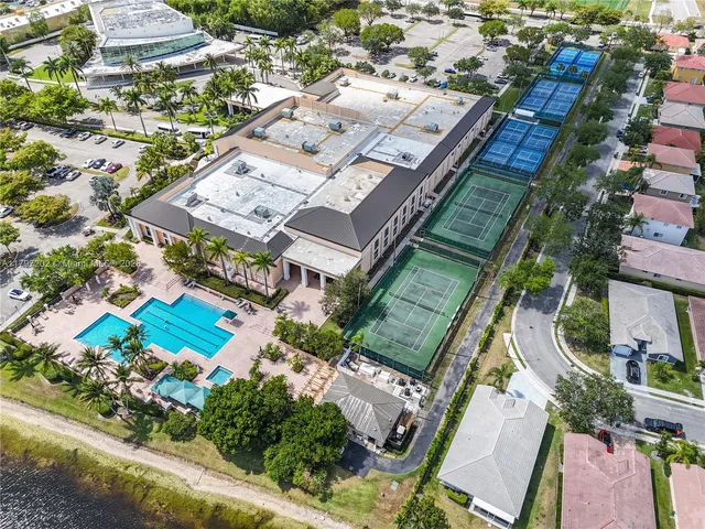 an aerial view of a residential houses with outdoor space and swimming pool