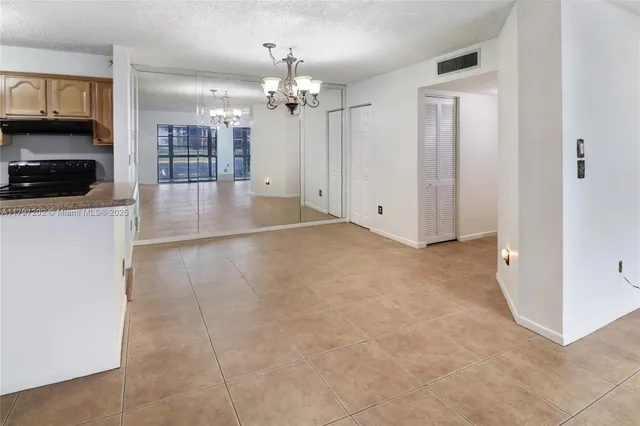 a view of a kitchen with a sink and cabinets