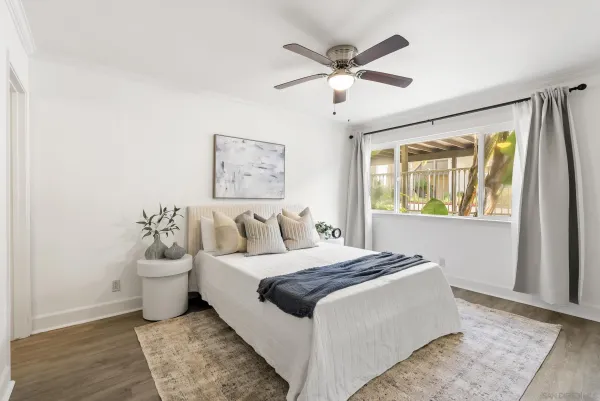 a bedroom with a large bed and a chandelier