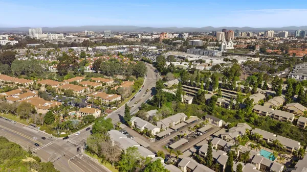 an aerial view of multiple houses with yard