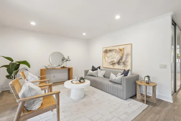 a living room with furniture a rug and a painting on the wall