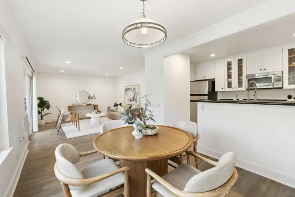 a kitchen with stainless steel appliances a dining table and chairs