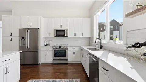 a kitchen with stainless steel appliances a sink cabinets and a refrigerator
