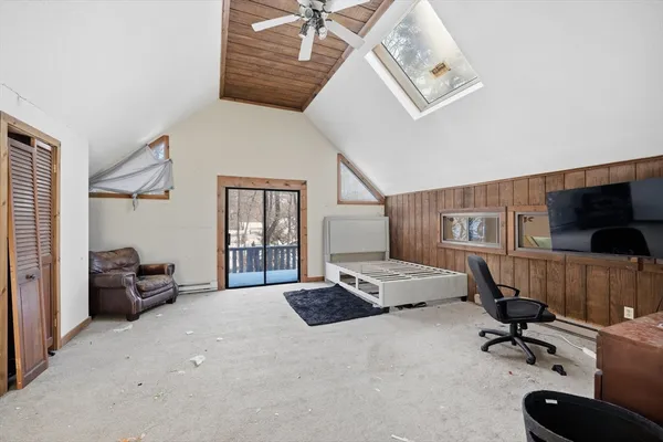a bedroom with furniture and a flat screen tv