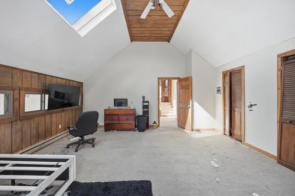 a view of a livingroom with workspace and a window