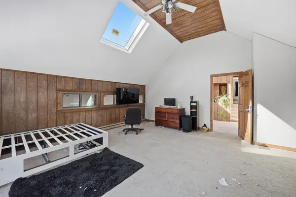 a bedroom with furniture and a potted plant