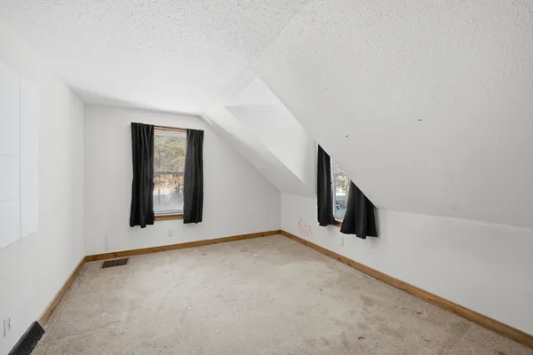 a view of an empty room with windows