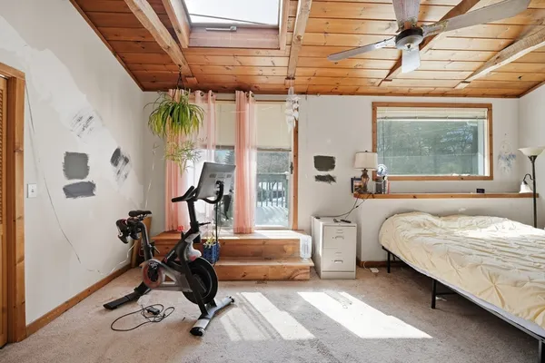 a bedroom with furniture and a window