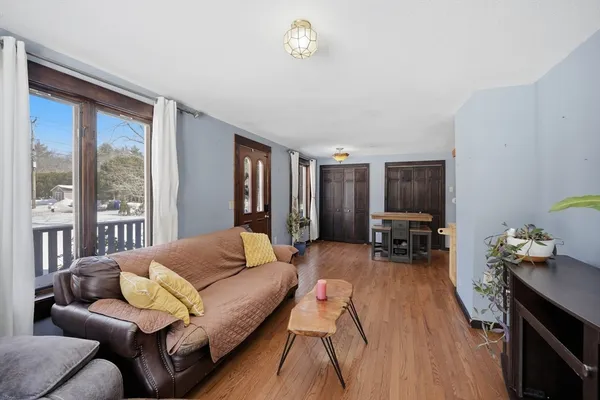 a living room with furniture a chandelier and a window