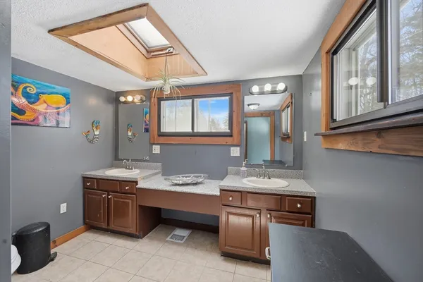 a room with furniture a chandelier fan and a window