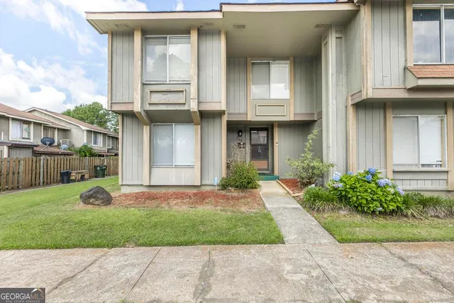a front view of a house with garden